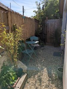 a backyard with a table and a fence at Seaside guest house a stone's throw from the beach in Dawlish