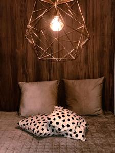 a room with a bed with a pillow and a lamp at Stylish house in the heart of Lapland in Tornio in Tornio