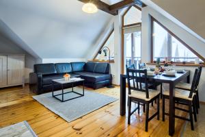 a living room with a couch and a table at VisitZakopane- Mallorca Apartment in Zakopane