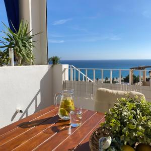 a table on a balcony with a view of the ocean at RESIDENCIAL OASIS 2 in Mojácar
