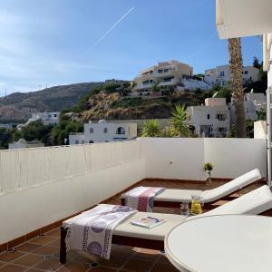 a patio with a table and chairs on a balcony at RESIDENCIAL OASIS 2 in Mojácar