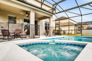 a swimming pool in the backyard of a house at Castle Street Memories in Kissimmee