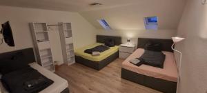 a small room with two beds and a couch at Pension-Maulburg in Maulburg