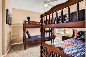 a bedroom with two bunk beds in a room at Castle Street Memories in Kissimmee