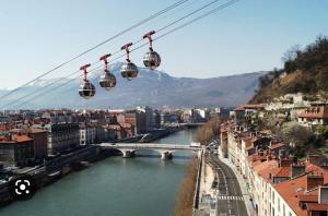 a view of a city with a bridge and a river at Europole 1 Gare de Grenoble & Centre Ville in Grenoble