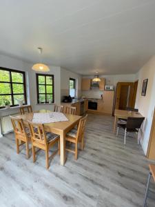 a dining room and kitchen with a table and chairs at Ferienhaus Jobelius in Beilstein +20 photos