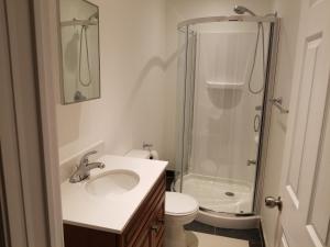 a bathroom with a sink and a shower and a toilet at A&I Cosy&Bright Apartments near Old Port and South Shore in Longueuil