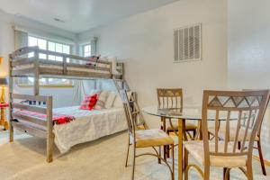 a bedroom with a bunk bed and a table and chairs at Cinnamon Teal Dream in Redmond