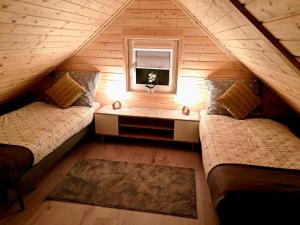 En eller flere senge i et værelse på Domki Na Wzgórzu - domek nr 1