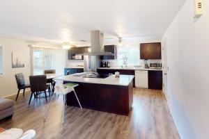 a kitchen and living room with a table and chairs at Gilham Gem in Eugene