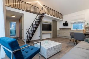 a living room with a spiral staircase in a loft at Amber Stone Apartment 2nd floor in Palanga