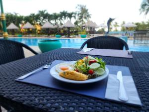 un plato de comida en una mesa cerca de una piscina en Andaman sea view private, en Patong Beach