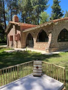 a brick building with a wooden fence in front of it at Casa Campo - Altamira in Campo Los Andes