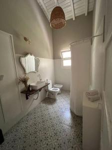 a bathroom with a toilet and a sink and a shower at Casa Campo - Altamira in Campo Los Andes