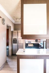 a kitchen with stainless steel appliances and a counter top at Modern Home in Pretoria in Pretoria