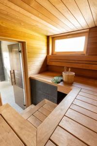 a bathroom with a sauna with a window and a tub at Tartu Pajuoja saunamaja in Tartu