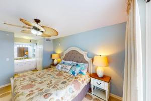 a bedroom with a bed and a ceiling fan at The Terrace at Pelican Beach 504 in Destin +42 photos