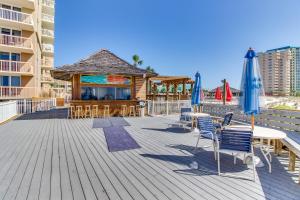 a deck with chairs and umbrellas and a bar at The Terrace at Pelican Beach 504 in Destin