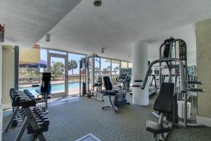 a gym with tread machines and a swimming pool at The Terrace at Pelican Beach 504 in Destin