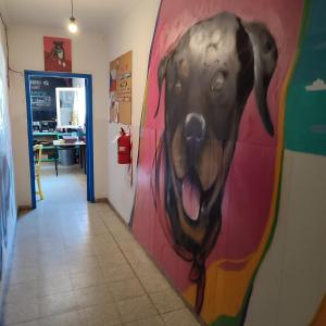 a painting of a dog hanging on a wall at rafa's house in Mendoza