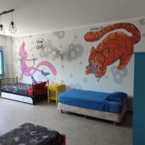 a room with two beds and a tiger mural on the wall at rafa's house in Mendoza