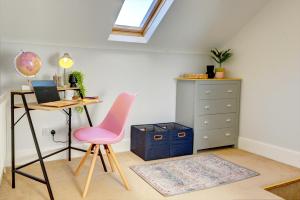 a room with a desk and a pink chair and a dresser at Regency Nest by Spa Town Property - Stylish 3 Bedroom Apartment on 2 Floors, Central Leamington Spa in Leamington Spa