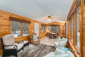 a living room with chairs and a table in a cabin at The River Retreat in Thompsonville