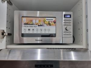 a microwave oven with a picture of food in it at Florya Studio Woluwe in Brussels