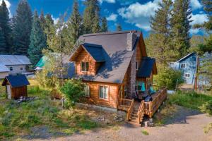 an image of a log cabin with a porch at Tranquil Aspens in McCall