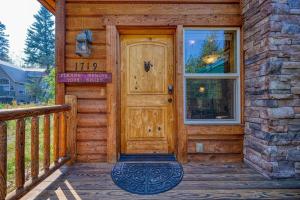 a wooden door on a house with a porch at Tranquil Aspens in McCall
