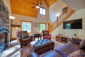 a living room with a fireplace and a tv at Tranquil Aspens in McCall