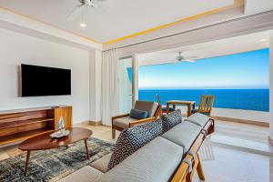 a living room with a couch and a television at Blue Horizon 701 in Puerto Vallarta