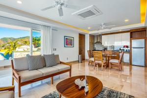 a living room with a couch and a table at Blue Horizon 701 in Puerto Vallarta