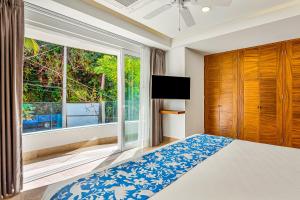 a bedroom with a bed and a large window at Blue Horizon 701 in Puerto Vallarta +31 photos