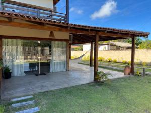 an outdoor patio with a pergola at Flats Corumbau in Corumbau