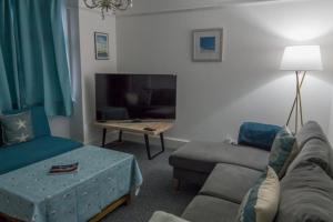 a living room with a couch and a table at Bexhill Luxury Sea Stay Flat 2 in Bexhill