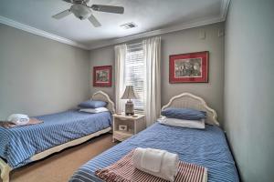 a bedroom with two beds and a ceiling fan at Fire Pit and Yard Charming Port Royal Home! in Port Royal