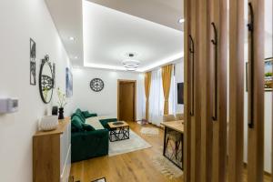 a living room with a green couch and a table at CENTRAL PARK ZLATIBOR in Zlatibor