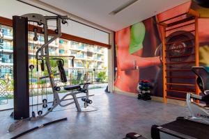 a room with a gym with a view of a building at Mana Beach #B217 - Quadrúplo por Carpediem in Porto De Galinhas