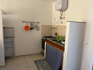 a small kitchen with a sink and a refrigerator at Beach Rotxa in Vila do Porto