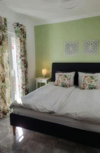 a bedroom with a large bed with two pillows at Olive Tree self-catering accommodation in Olvera
