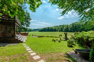 a yard with a house and a field at Chata U Tří lišek - na samotě u lesa 