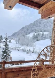 a porch with a view of a snow covered mountain at Heutaler Hof - Hotel im Naturidyll in Unken
