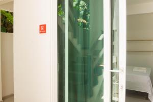 a glass door with a sign that says exit at Além dos Sonhos in Cayru