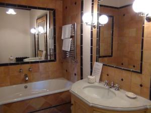 a bathroom with a tub and a sink and a mirror at Palazzo Prugnoli, Monte Santa Maria Tiberina, 8 Bedroom villa with private pool & superb views in Perugia +49 photos