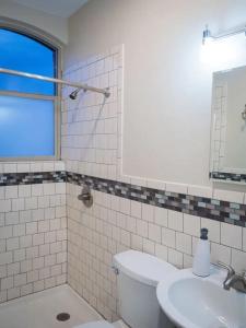 a bathroom with a toilet and a sink at The Lofts at Myrtle in El Paso