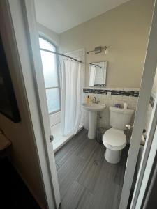 a bathroom with a toilet and a sink at The Lofts at Myrtle in El Paso