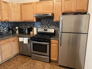 a kitchen with stainless steel appliances and wooden cabinets at The Lofts at Myrtle in El Paso