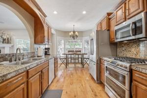 a kitchen with wooden cabinets and stainless steel appliances at Redwick in Meridian