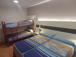 Postel nebo postele na pokoji v ubytování Hostal Restaurante El Castillo